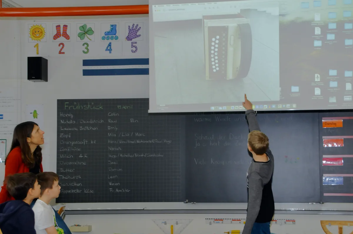 Man sieht Schulkinder ihr Schulprojekt vorstellen.